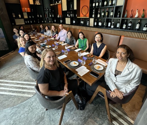 International Women's Day Roundtable Luncheon | A group of women and a man seated around a long table